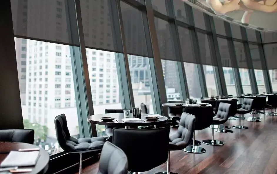 A restaurant with a lot of windows and tables and chairs