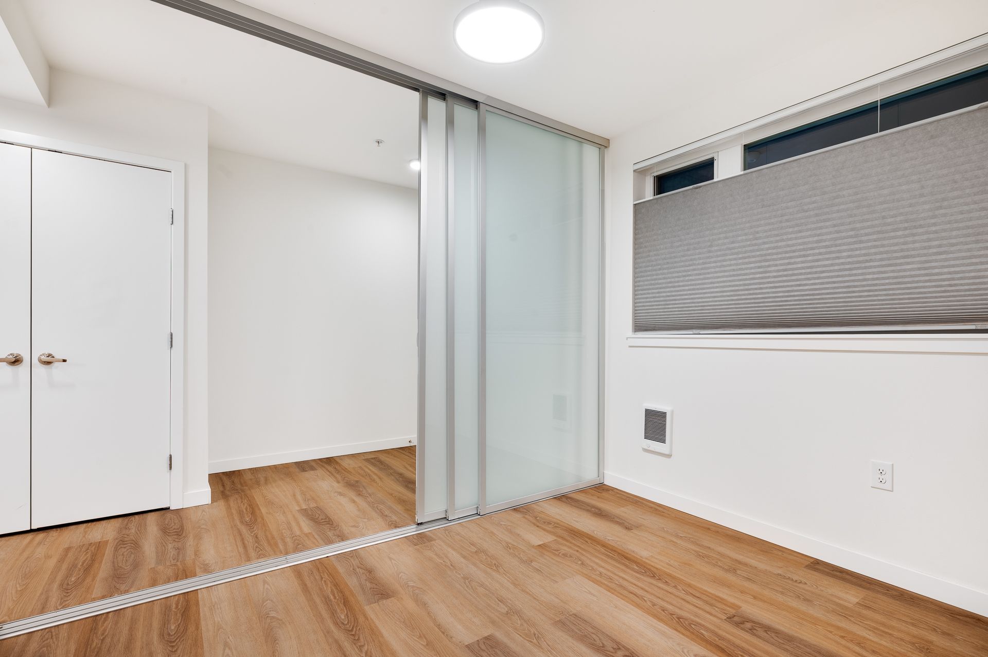 Photo of a bedroom with sliding closet doors