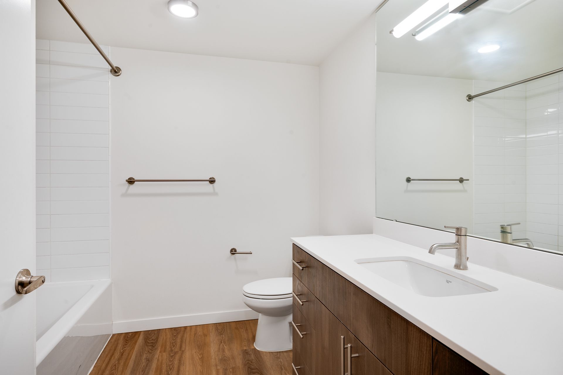 Photo of a bathroom, showing a wide countertop and a bathtub/shower combo