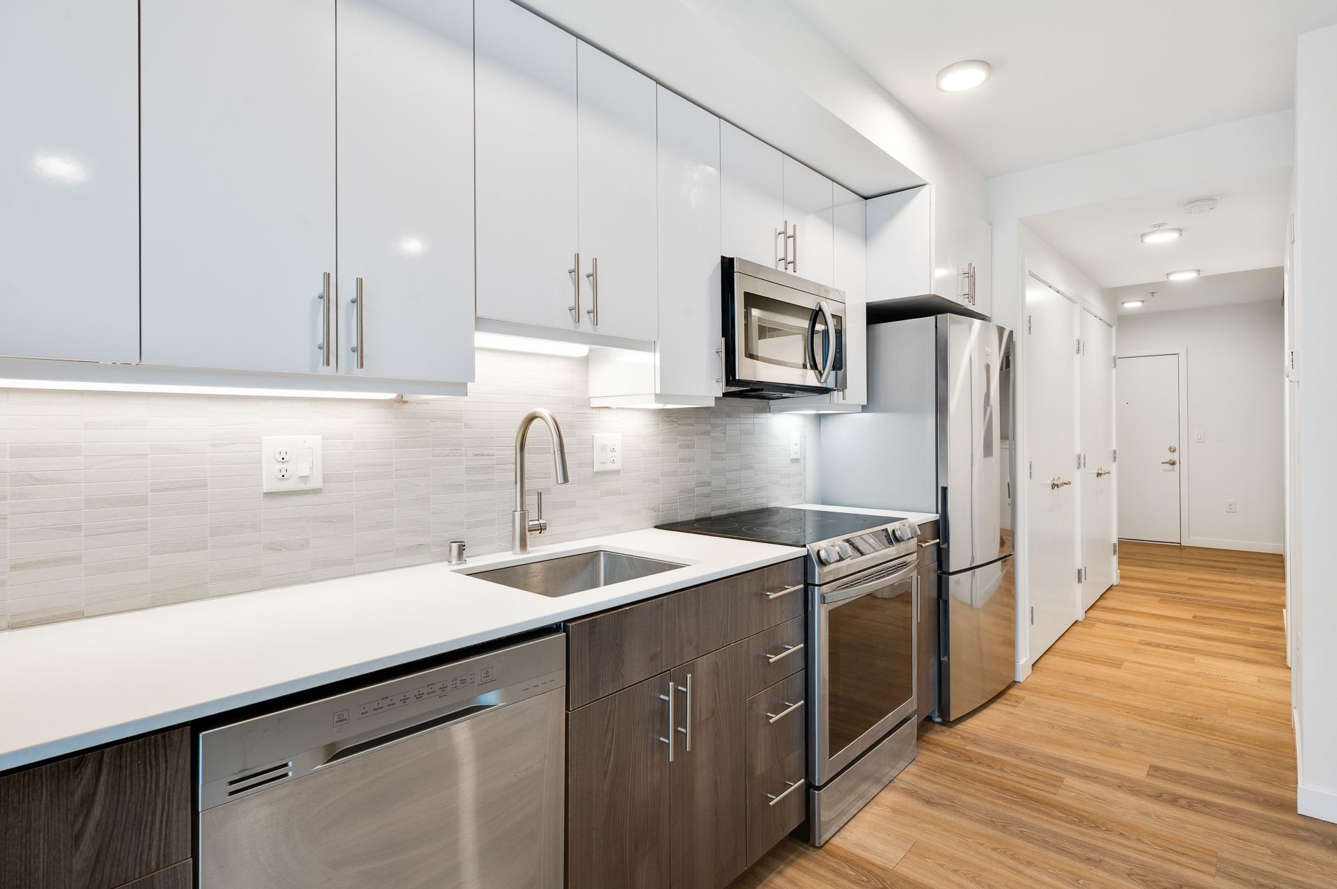 Photo of a long kitchen with new appliances