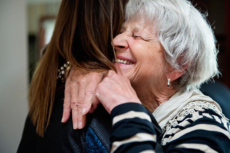 Senior Woman Hugging — Columbia, MO — Hillcrest Assisted Living