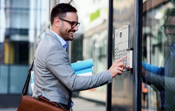 A man is using a keypad to open a door.