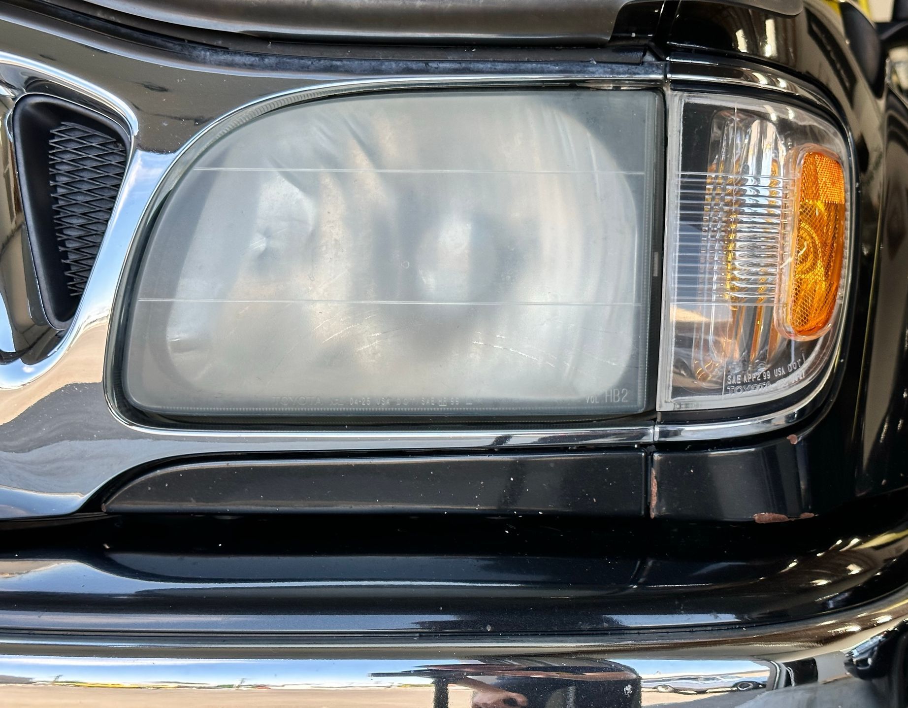 A close up of a black car 's headlight