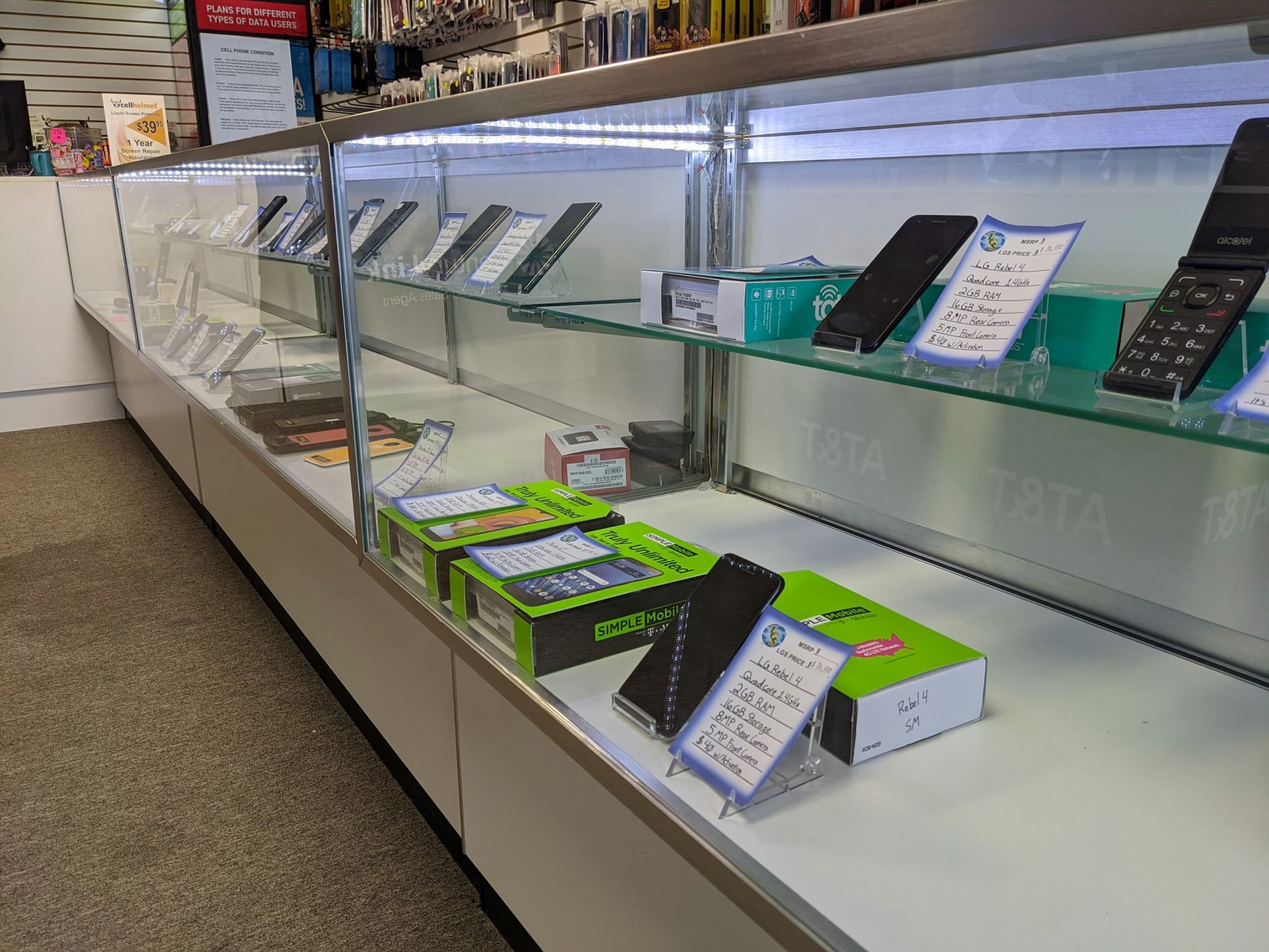 A display case in a store contains cell phones and accessories.
