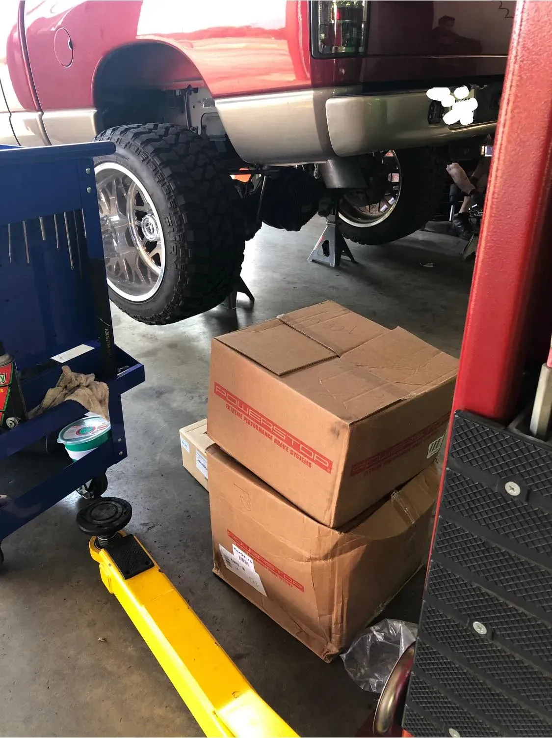 Boxes Stacked Beside a Red Truck — Killeen, TX — Alignment & Brakes Specialist