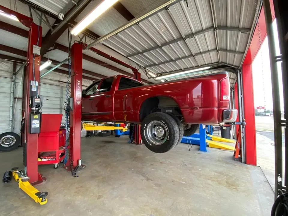 Red Truck on a Lift — Killeen, TX — Alignment & Brakes Specialist