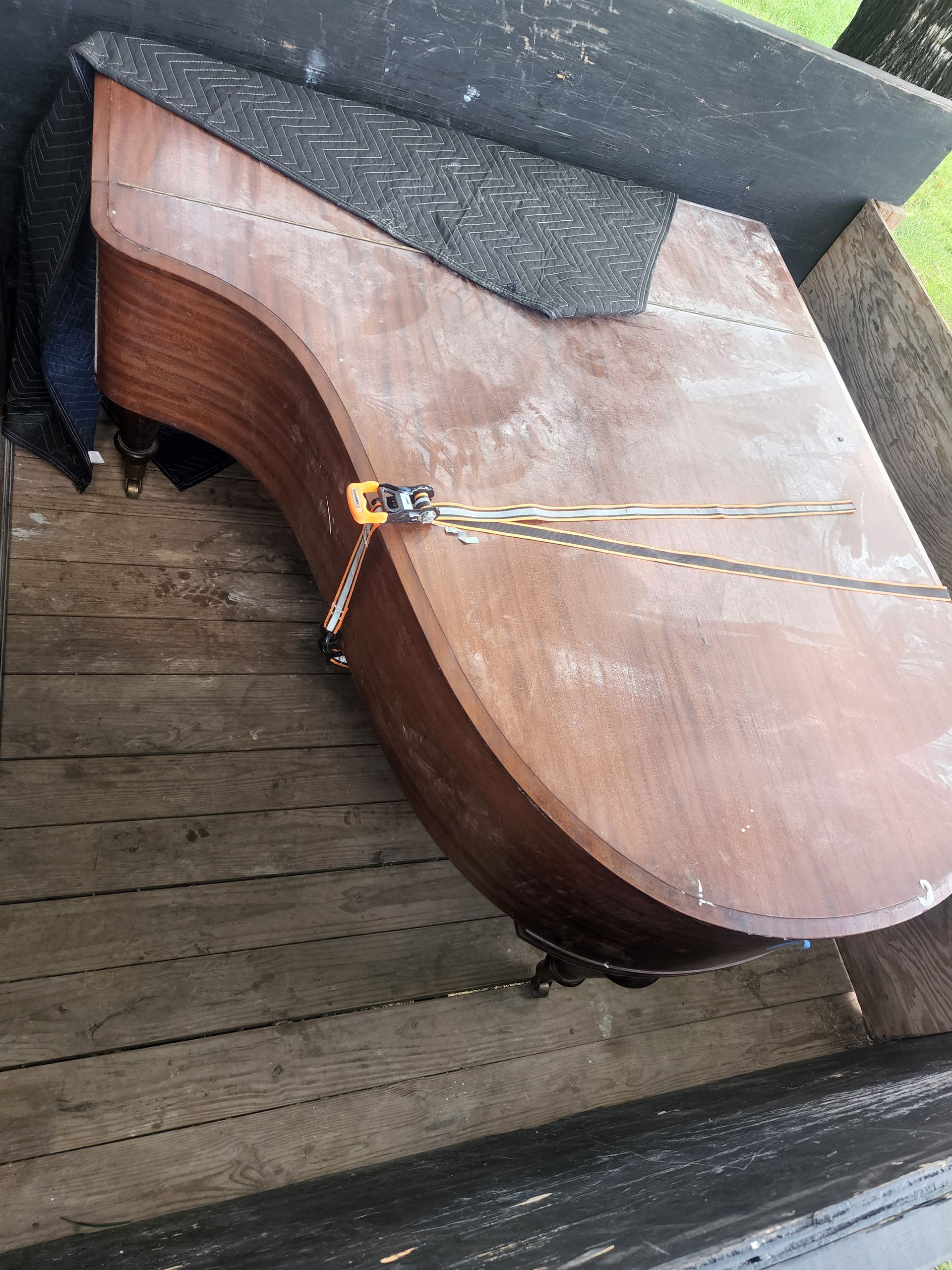 Wooden saddle in a wooden box with straps and chain.
