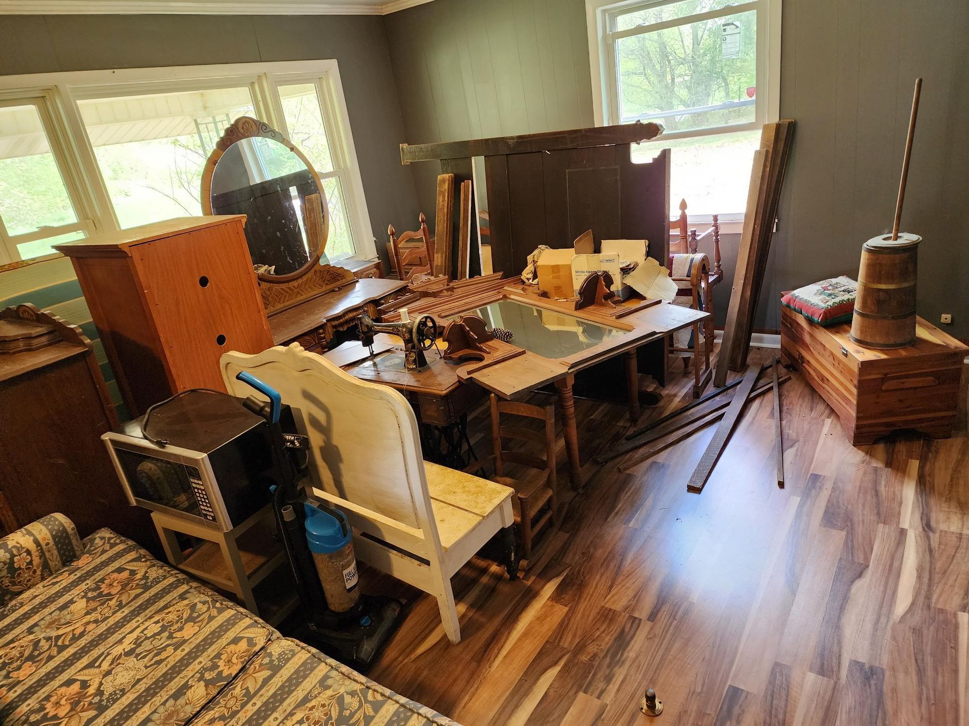A living room filled with furniture and a vacuum cleaner.