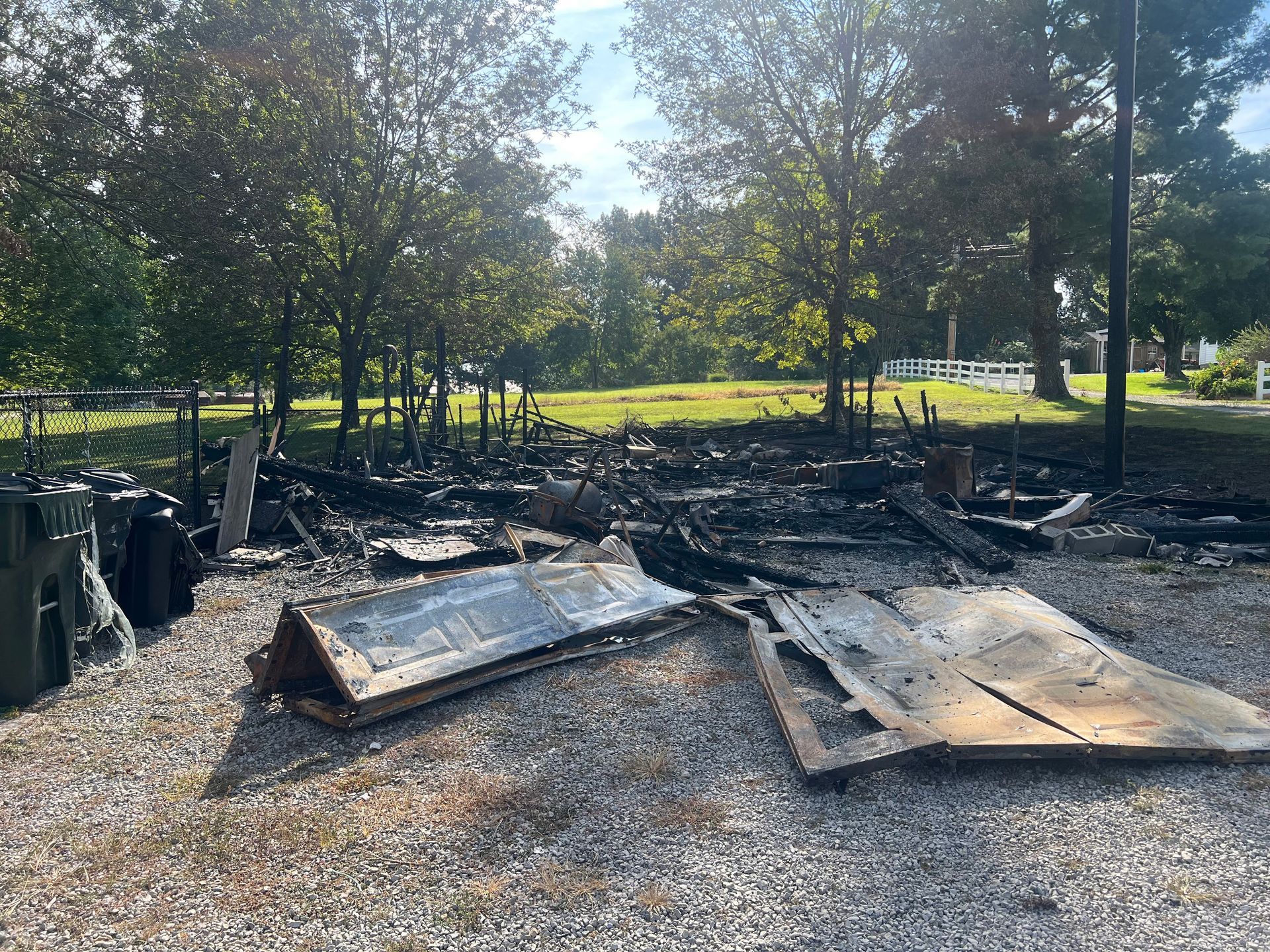A pile of wood is sitting on the ground in a park.