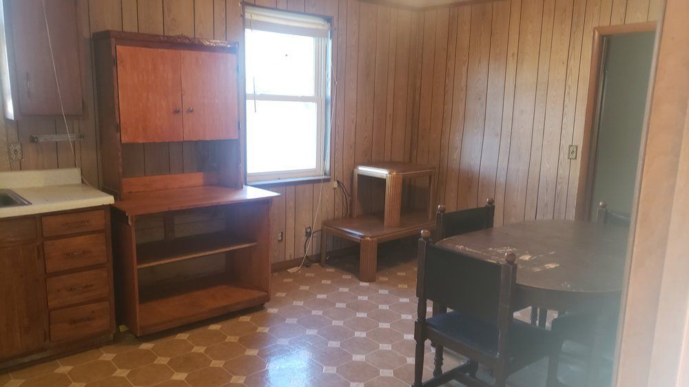 A kitchen with a table and chairs and a window.