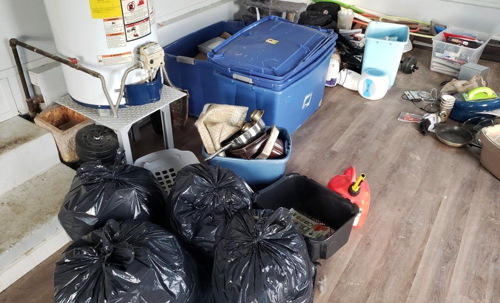 A room filled with lots of trash bags and boxes.