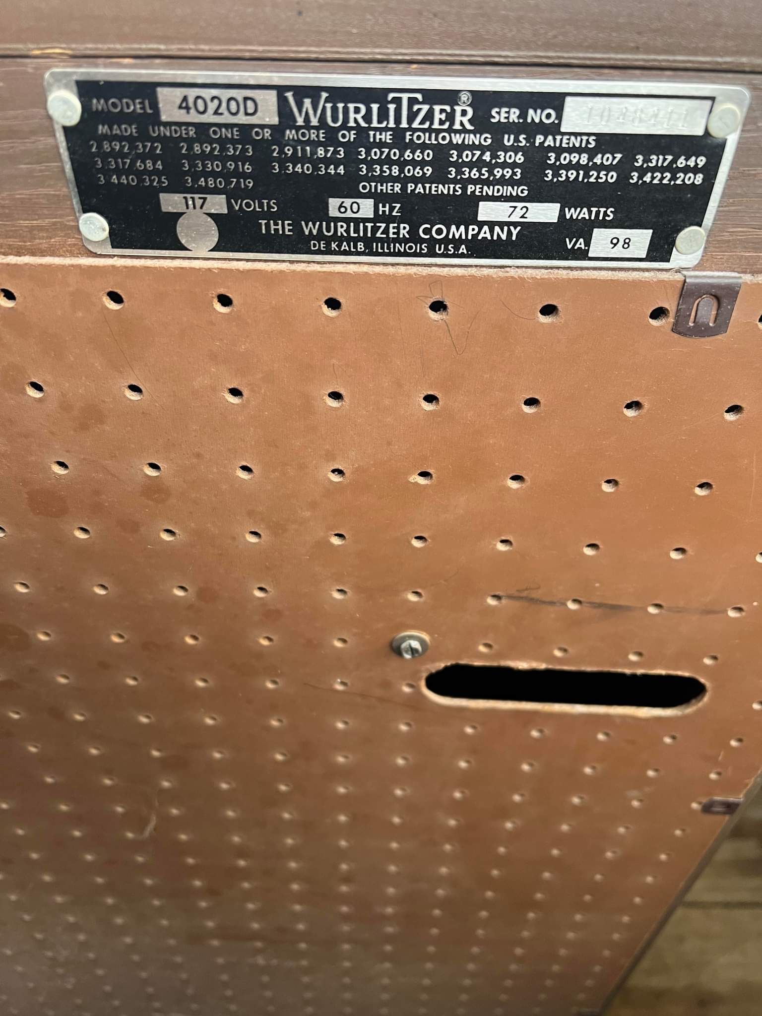 Close-up of a Wurlitzer model 4020D jukebox with a metal identification plate.