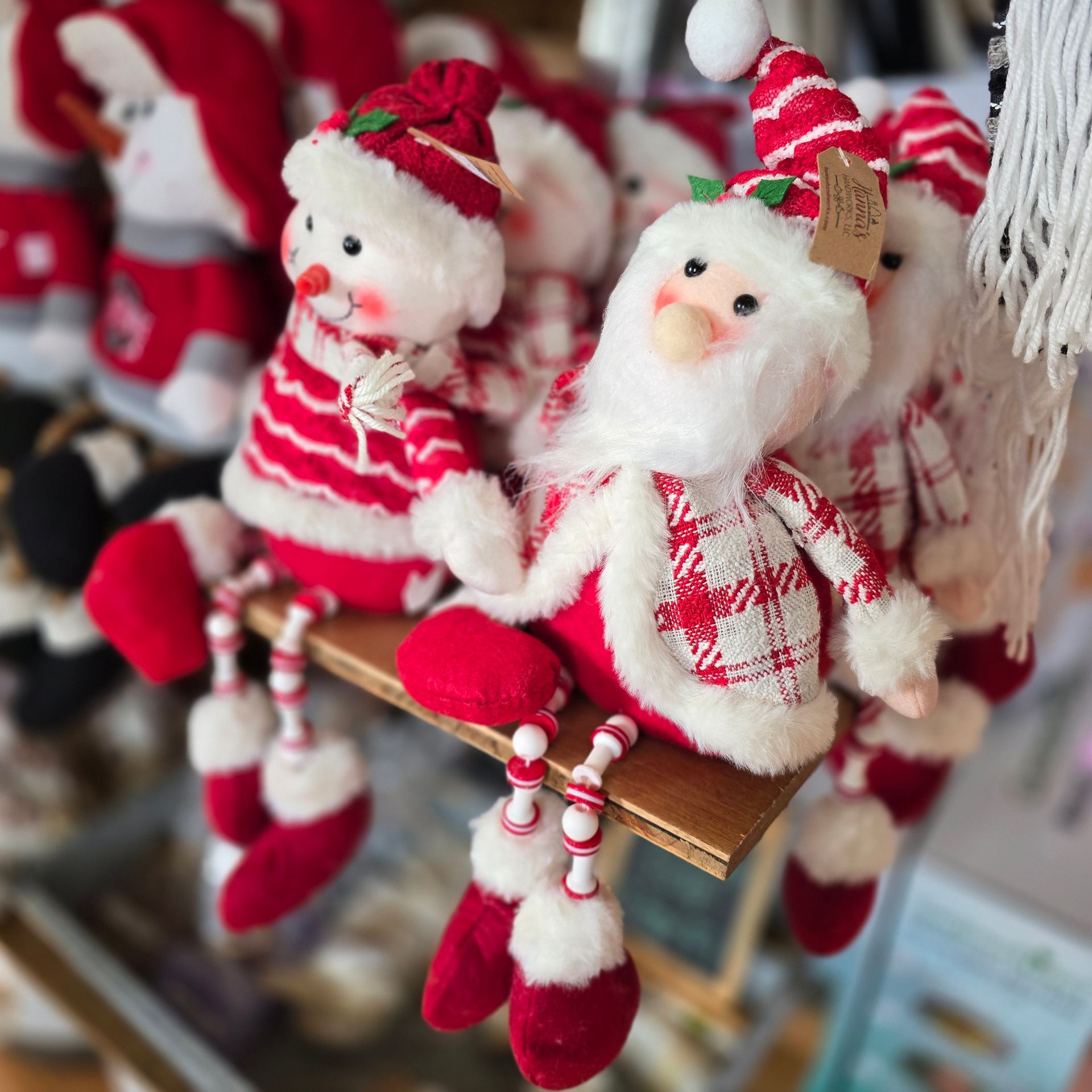 Stuffed Santa clauses are sitting on a table at The Petal Patch greenhouse in Fremont, OH