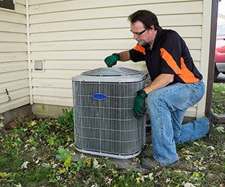 A/C Installation — Repairman Checking On Air Conditioner  in Hillsboro, MO