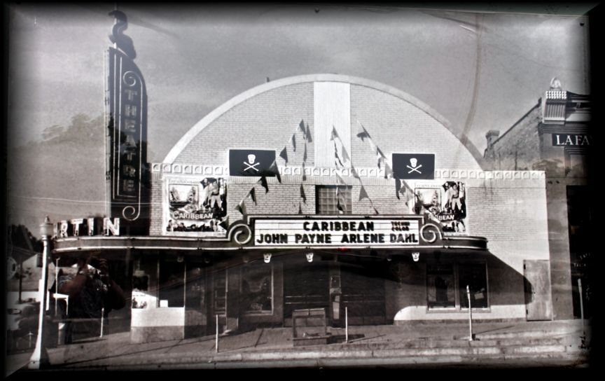 A black-and-white photo of a theater marquee advertising the movie