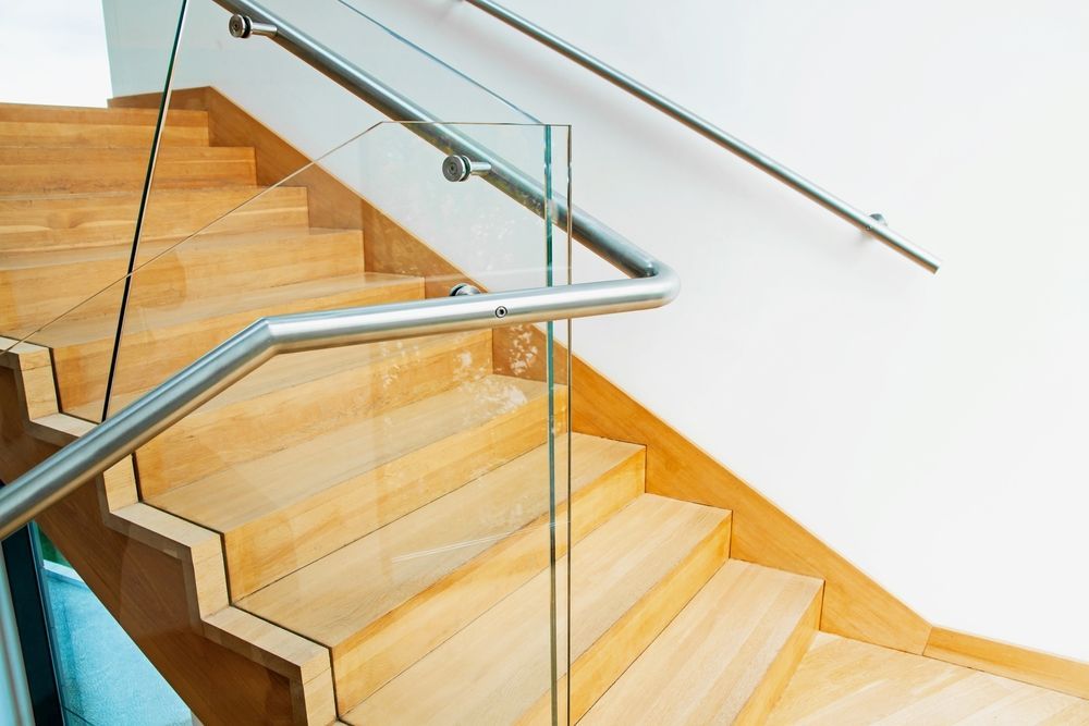 Modern Architecture Interior With Elegant Wooden Stairs and Glass Balustrade — Glass in Kiama, NSW