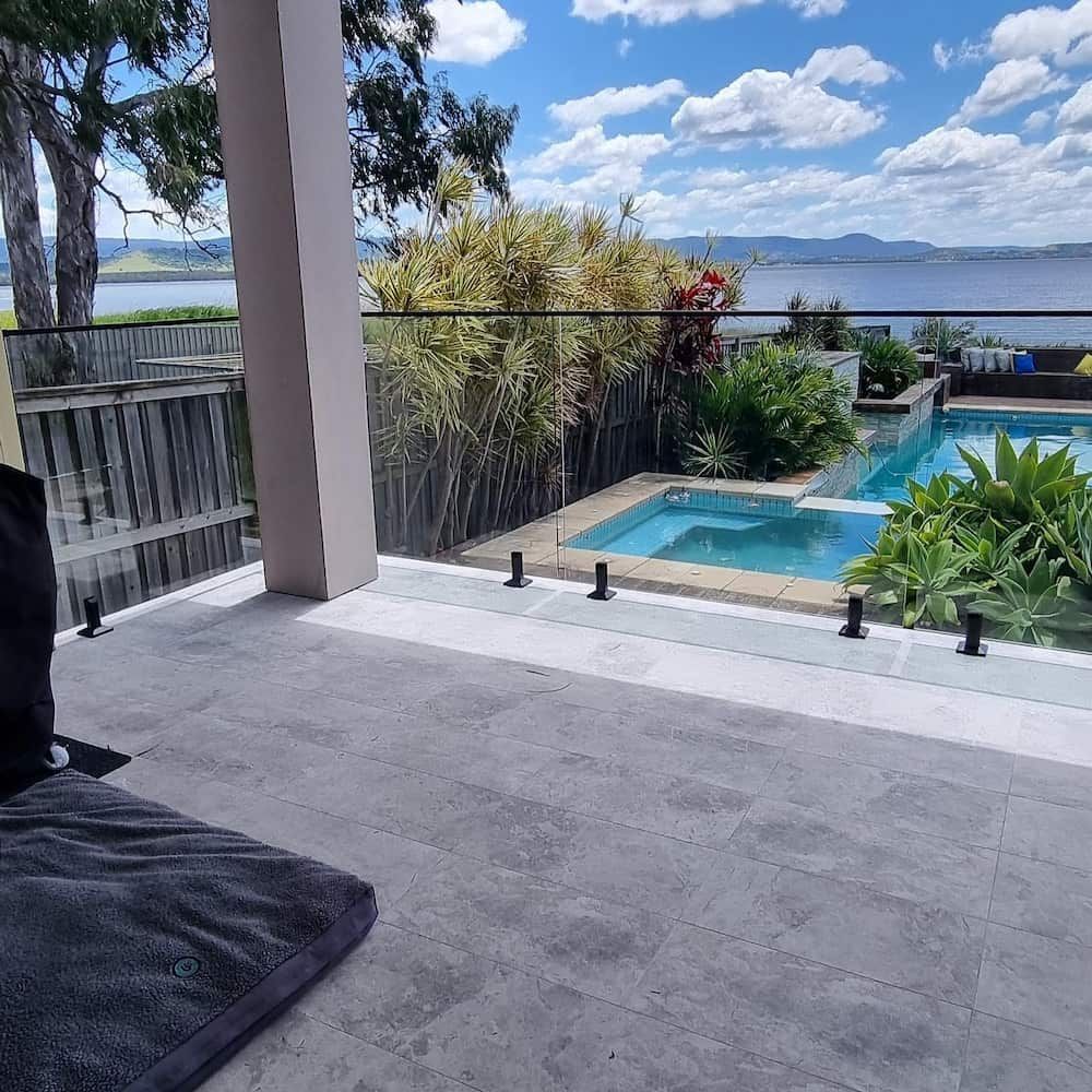 A Serene Patio Overlooks a Lush Garden With a Small Pool and Hot Tub