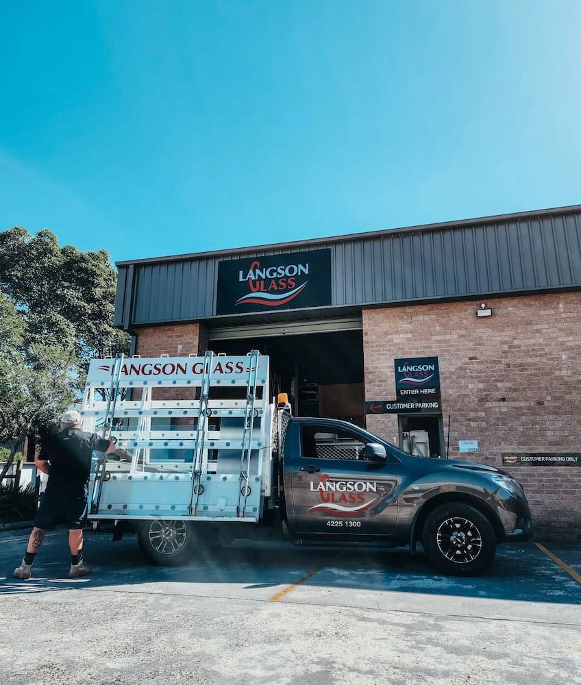 A Langson Glass Pickup Truck in Front of a Brick Building — Langson Glass in Wollongong, NSW 