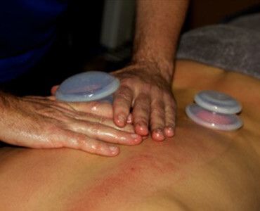 A Man Is Giving A Woman A Massage On Her Back – Chermside, QLD - Hands From Heaven Remedial Therapy Clinic