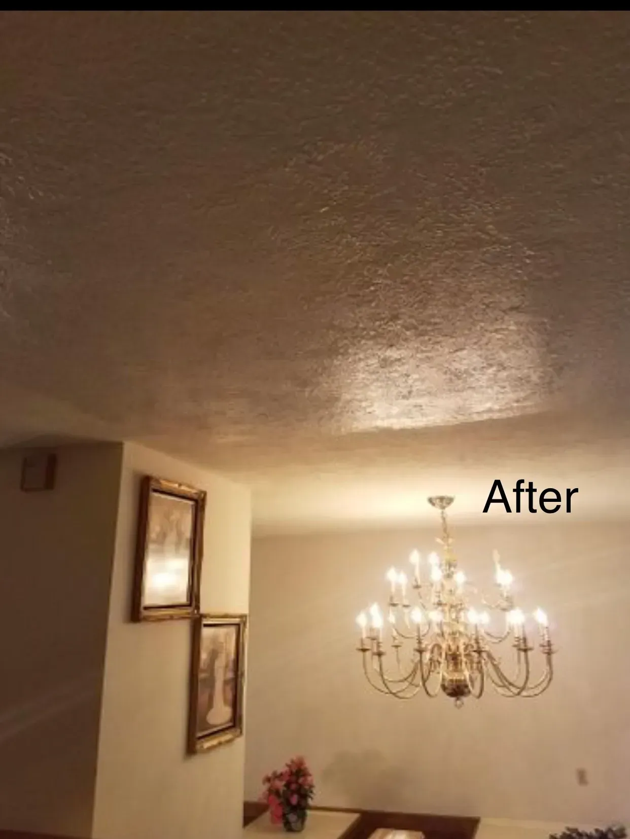 Dining room ceiling after painting; textured, with a chandelier and framed art on the wall.