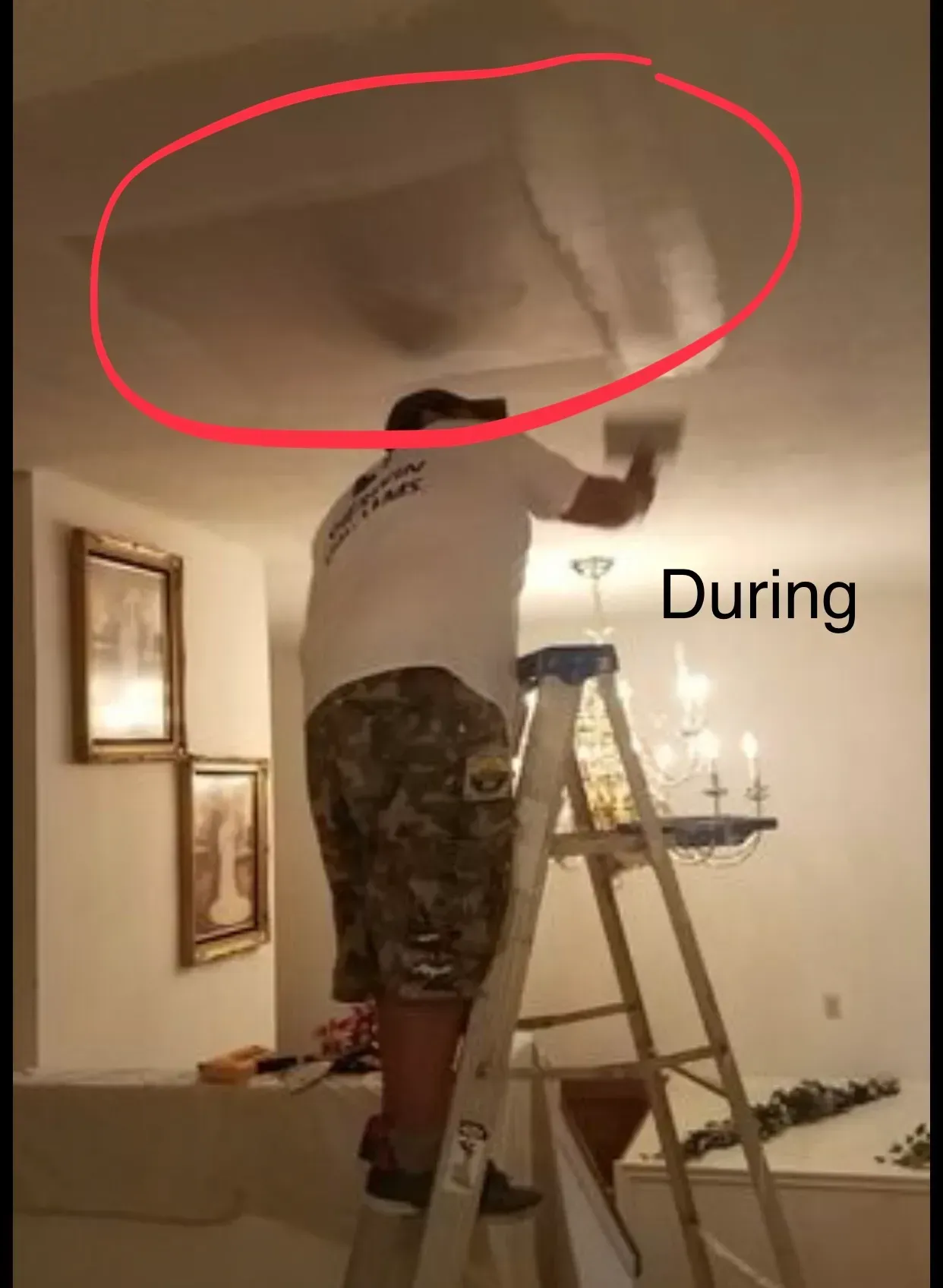 A man on a ladder is repairing ceiling damage, interior setting.