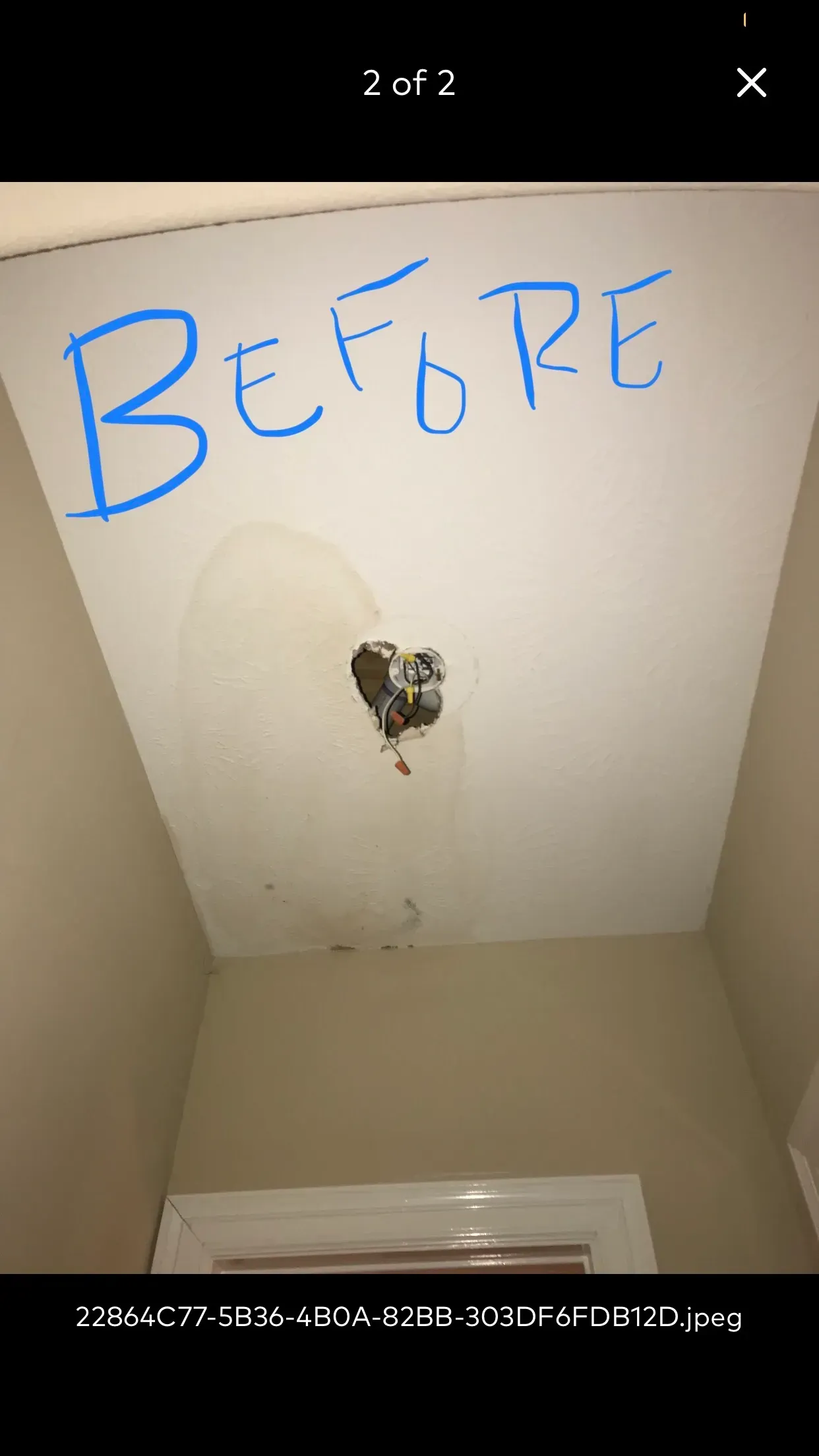 Hole in a ceiling with water damage. 