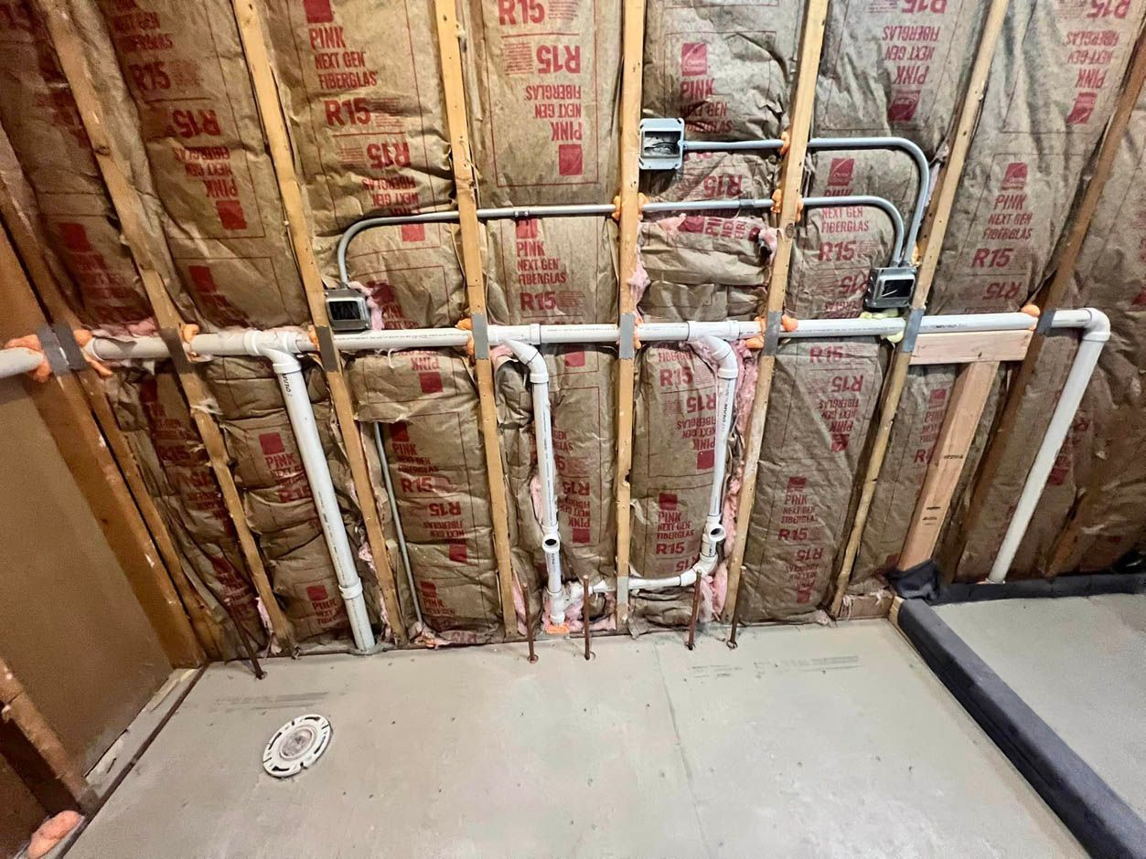 A room with a lot of pipes hanging from the ceiling.