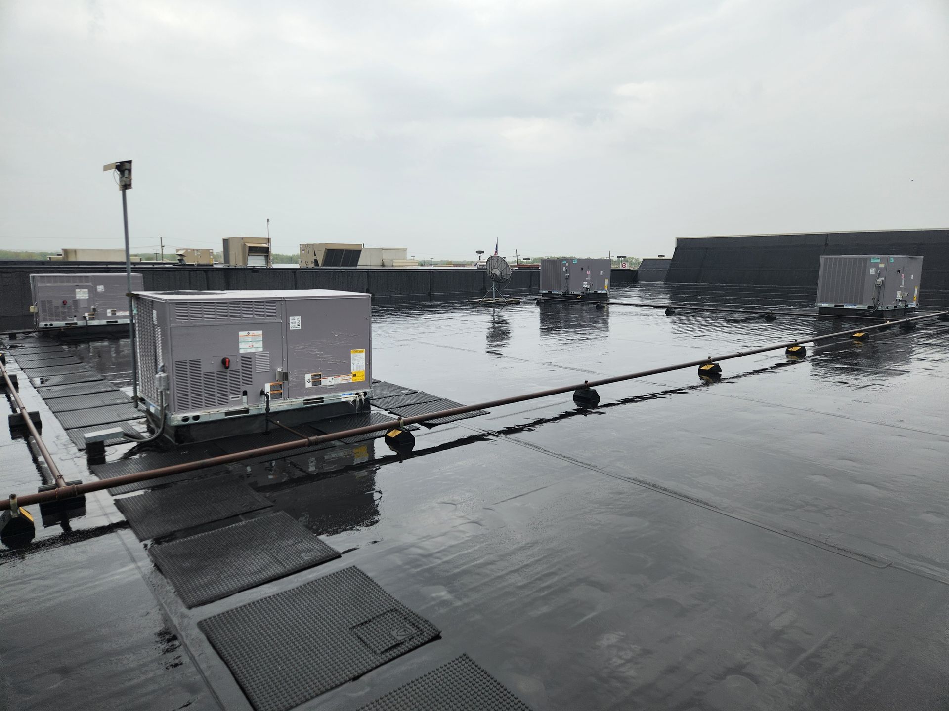 A rooftop with a lot of air conditioners on it
