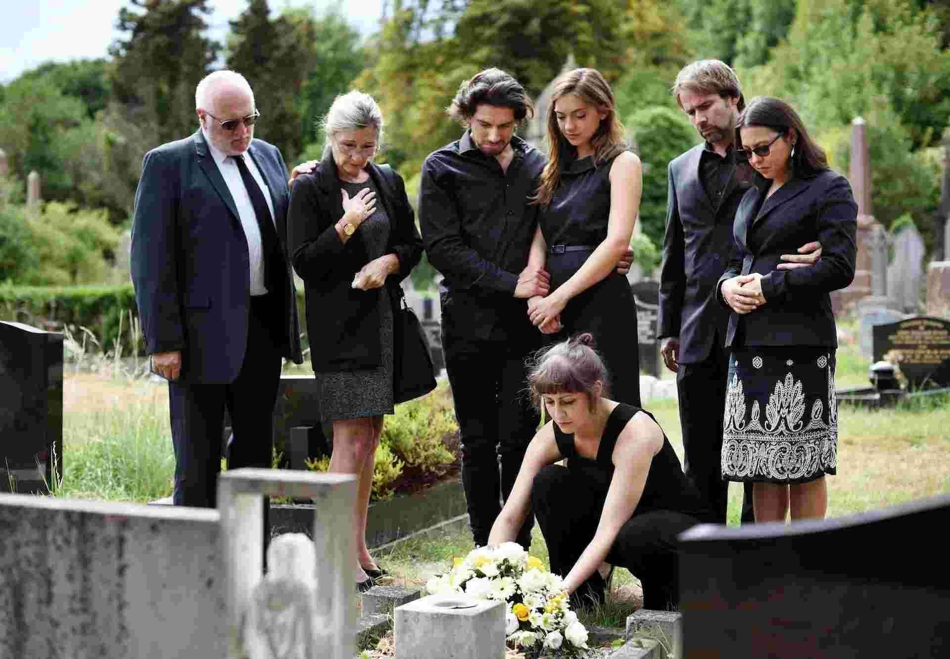 Graveside Services Group gathered at graveside placing flowers during a burial service in Austin, TX