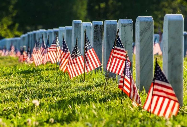 Veteran's Services Rows of white headstones with small American flags placed in a memorial cemetery in Austin, TX