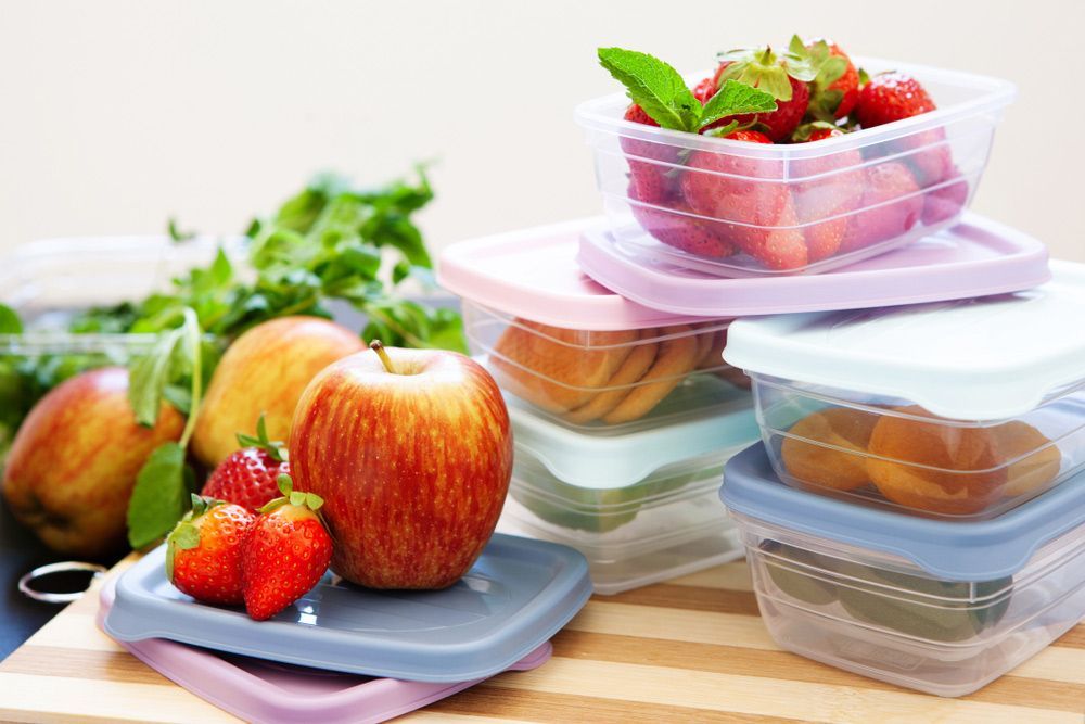 A Stack Of Plastic Containers Filled With Fruit And Vegetables — Kym Connolly Wellness Coach in Svensson Heights, QLD