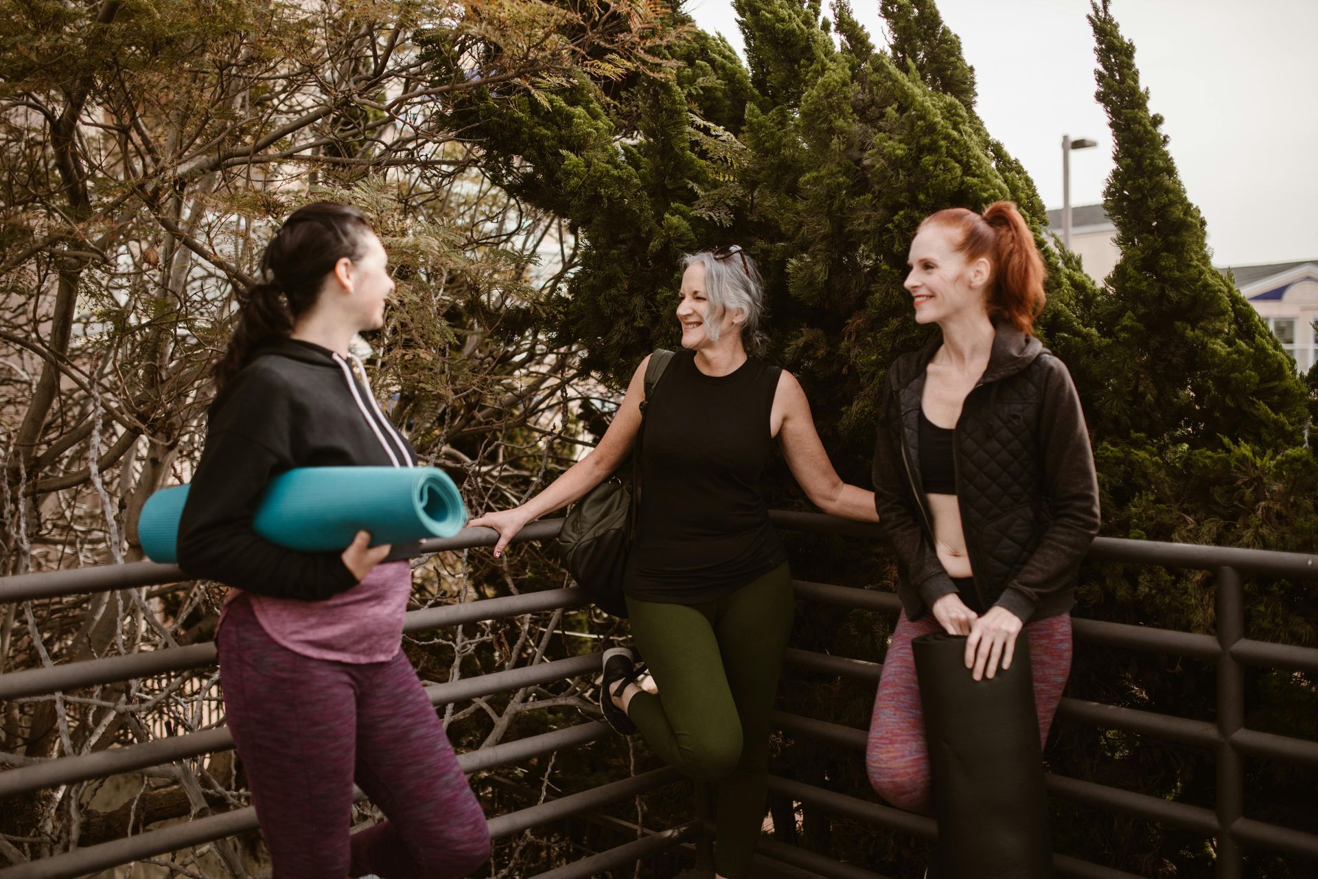 A Group of Ladies Talking with Yoga Mats — Kym Connolly Wellness Coach in Svensson Heights, QLD