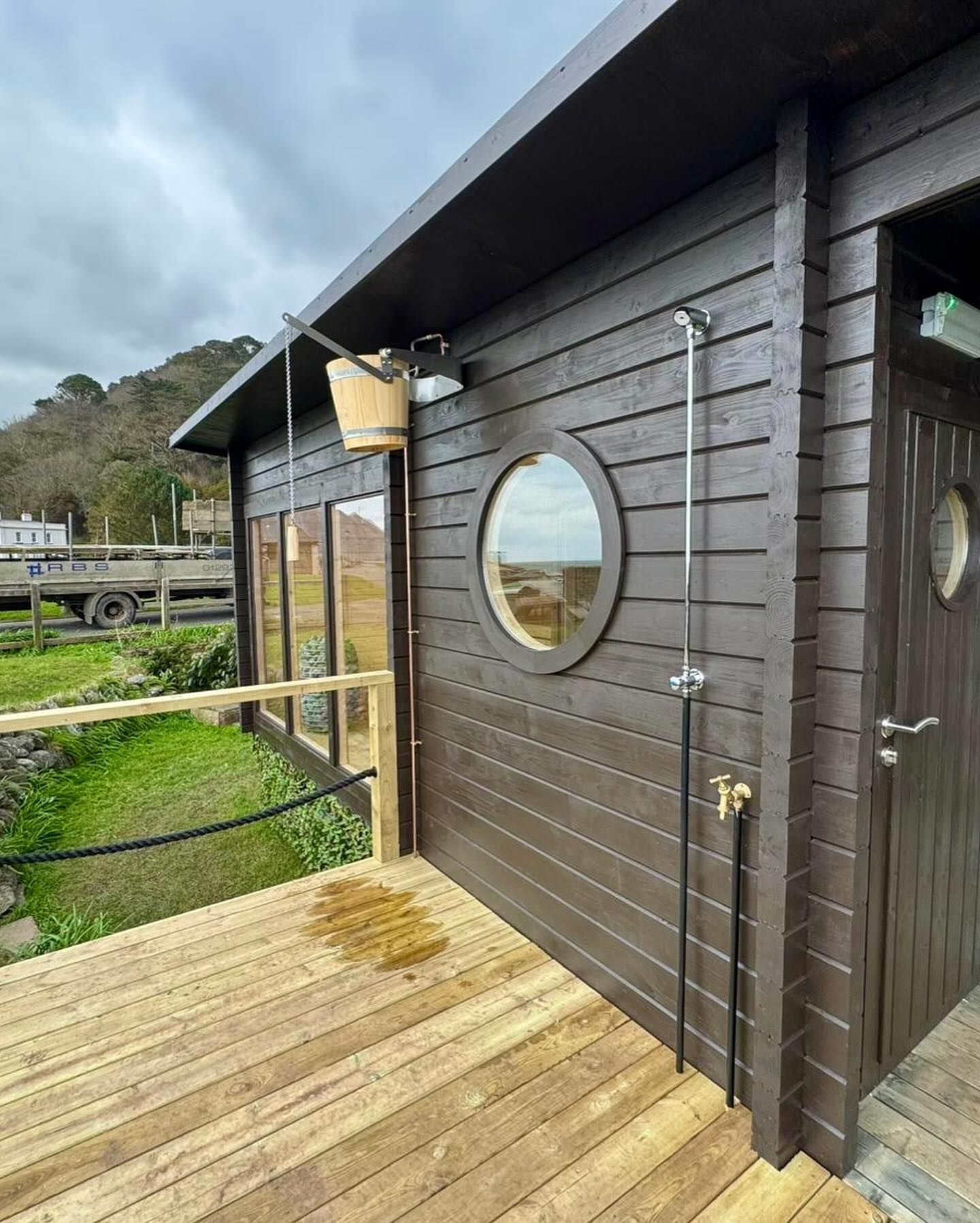 The exterior of a sauna on the seaside.