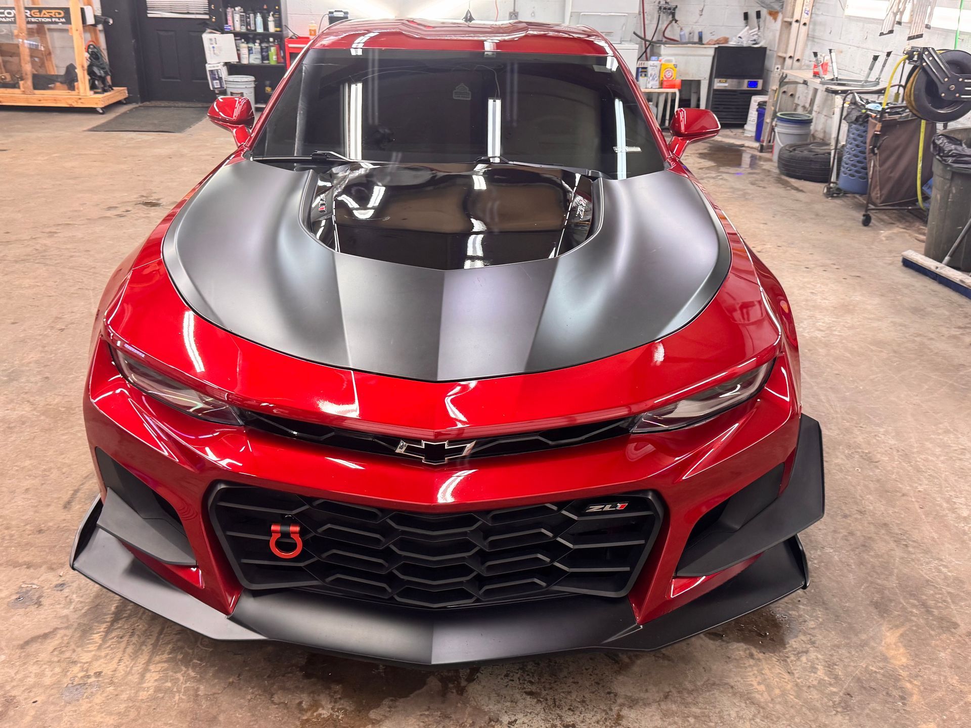 Red Camaro with black hood and front splitter.