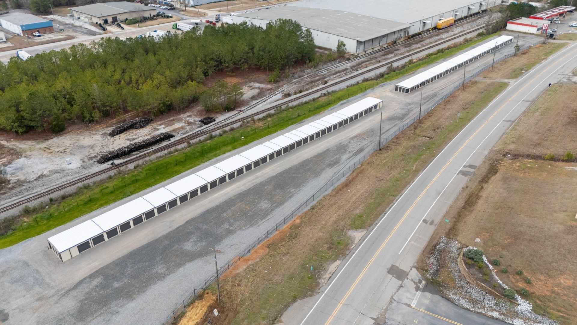 A man is carrying boxes on a cart in a warehouse.