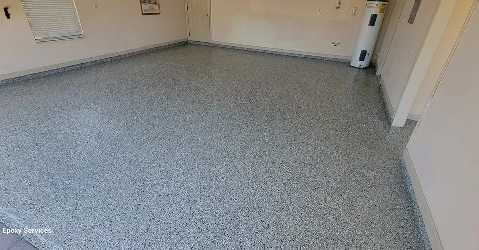 Gray speckled epoxy floor in an empty garage.