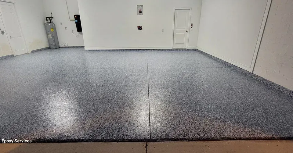 Garage with gray speckled epoxy floor and white walls.