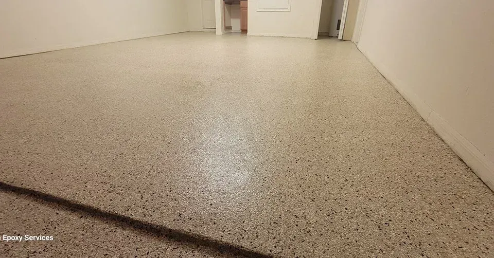 Polished concrete floor in an empty room with white walls.