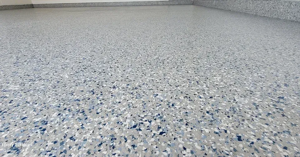 A gray and blue speckled epoxy floor in a room.