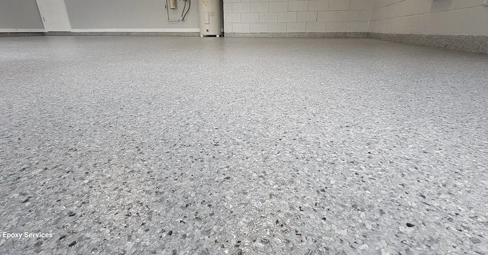 Gray epoxy-coated garage floor with speckled aggregate.