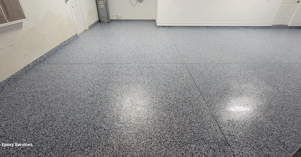 Gray speckled epoxy floor in a room with white walls.