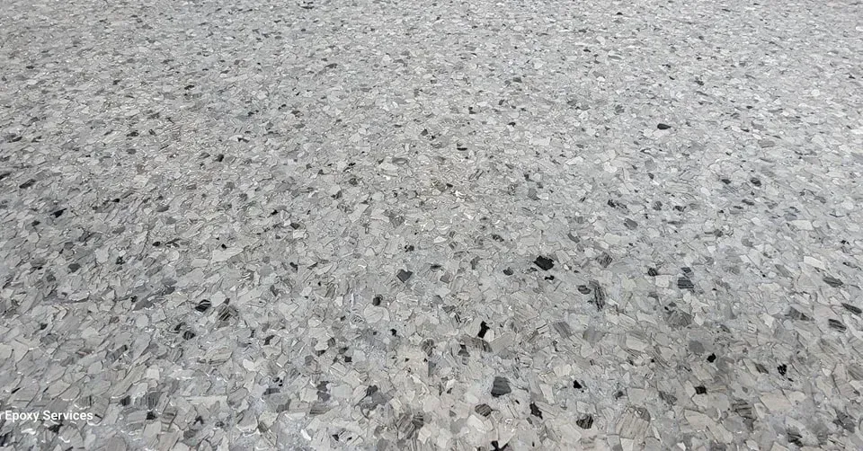 Gray stone aggregate floor with flecks of black.