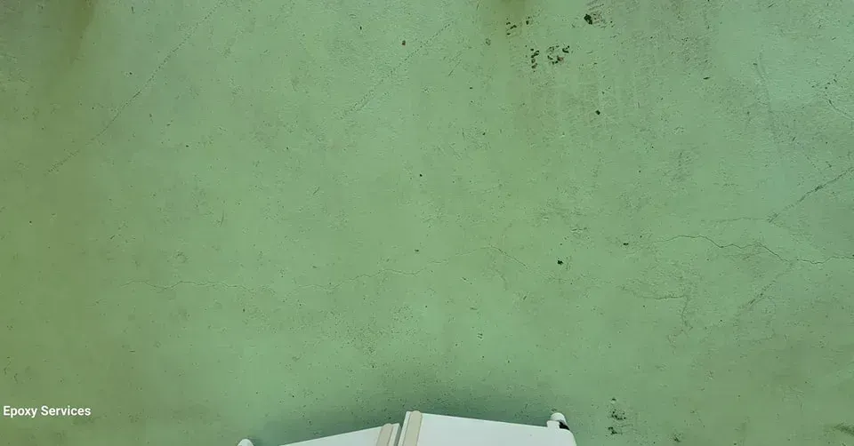 Green wall with a small amount of dark spots. Bottom edge includes white object.