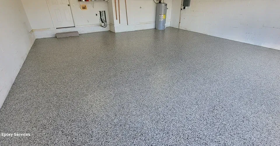 Garage with gray speckled epoxy flooring.