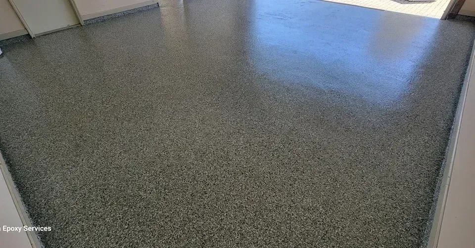 Polished gray concrete garage floor with glossy finish.