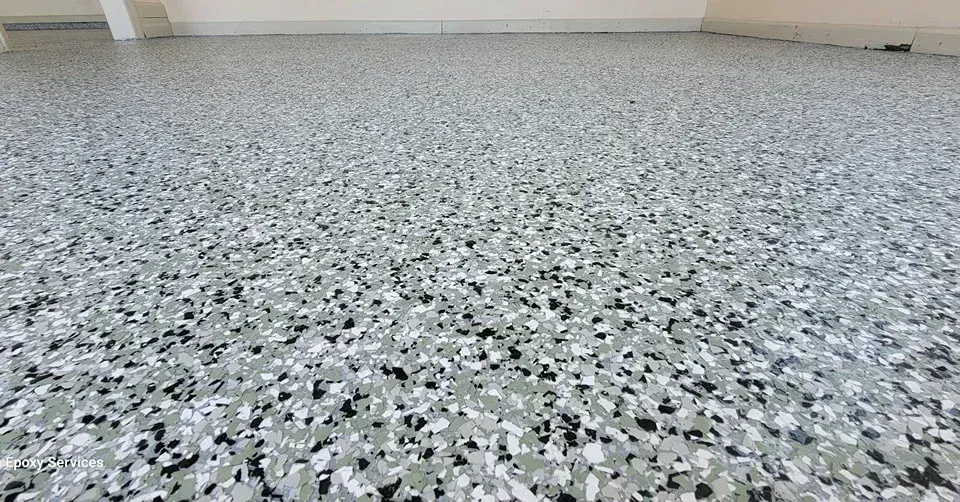 Gray, black, and white speckled epoxy garage floor.