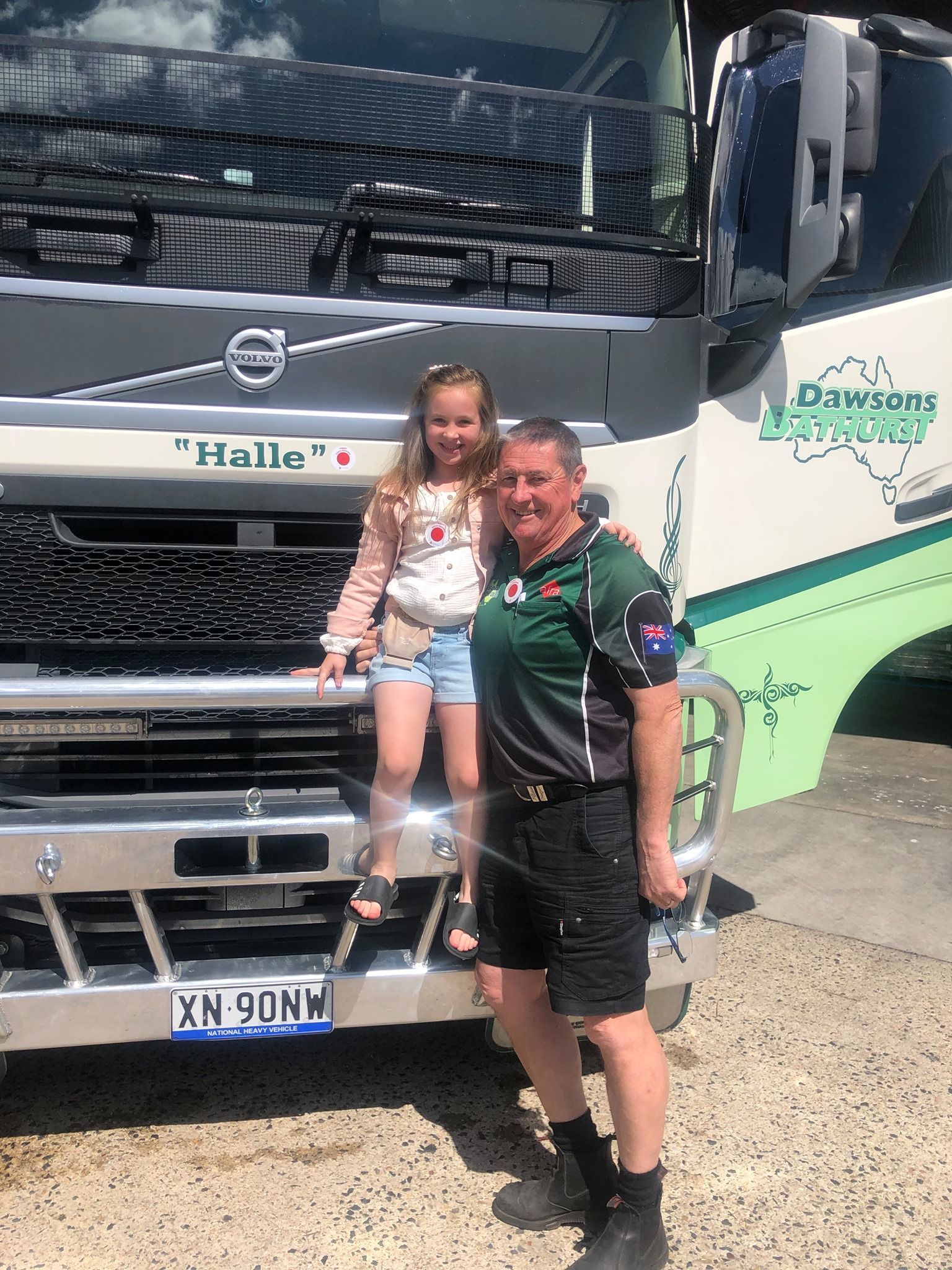 A man is standing in front of a large truck with a little girl — Dawson's Removals In Kelso, NSW