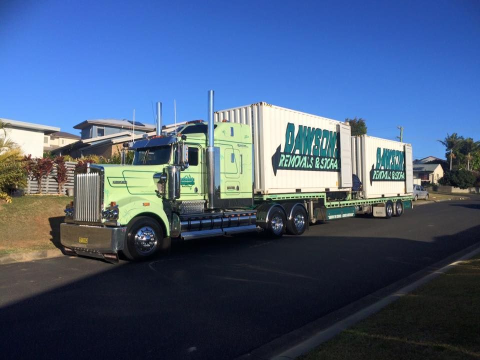 Green Semi Truck Hauling a Trailer on A Suburban Street — Dawson's Removals In Kelso, NSW