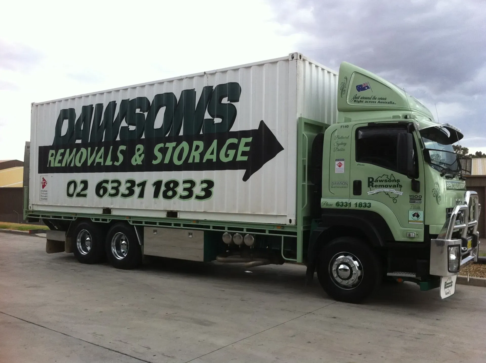 Green and White Dawson's Removals & Storage Truck Parked on Pavement — Dawson's Removals In Kelso, NSW