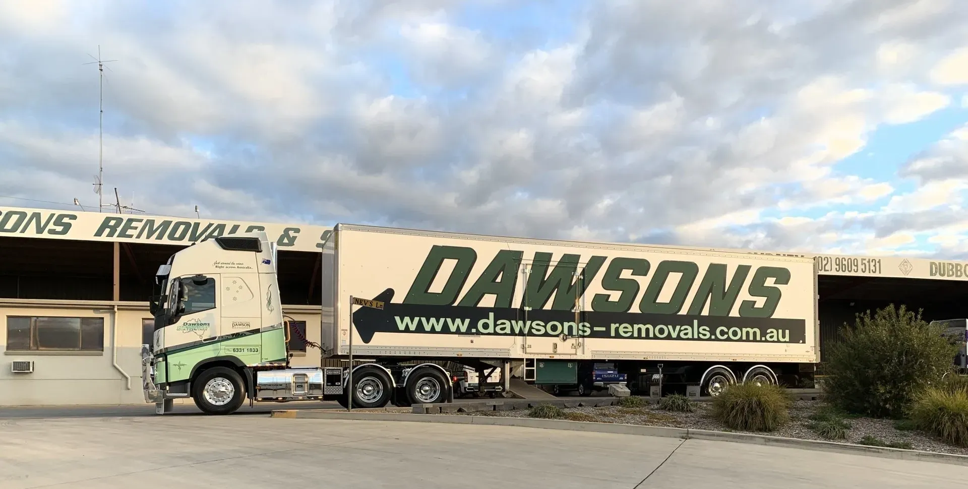 Dawsons Removals Truck Parked Outside a Warehouse Under a Cloudy Sky — Dawson's Removals In Kelso, NSW